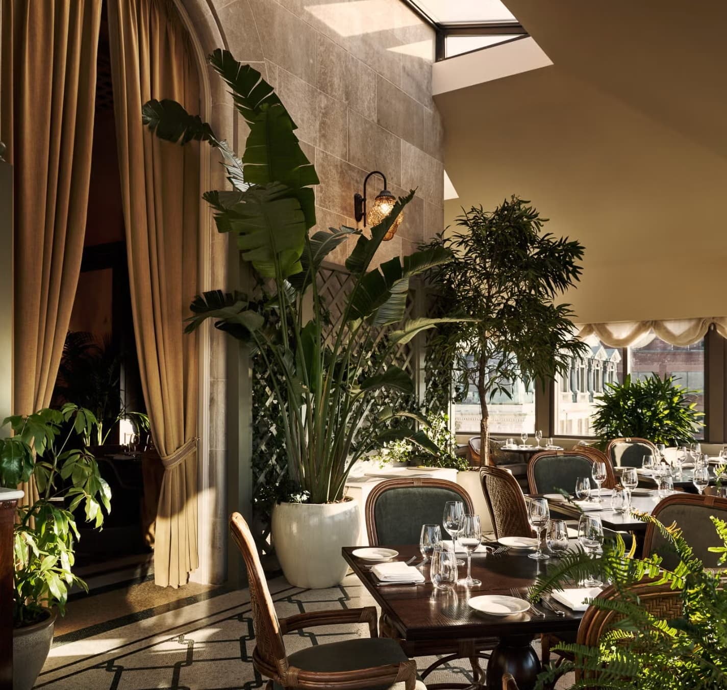 The palm-filled dining room at Ned's Club Washington DC, with vaulted ceilings and classical murals.