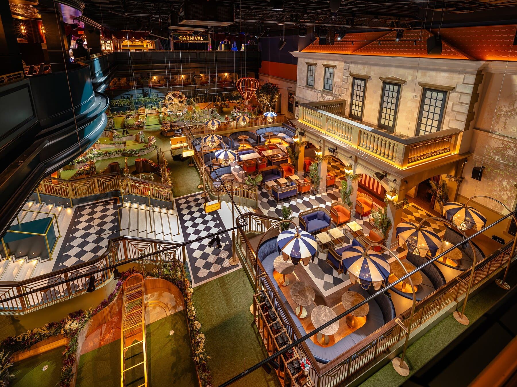 The crazy golf course and bars inside Swingers Las Vegas, lit with theatrical stage lighting.